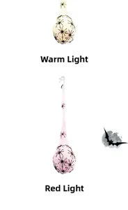 Detail of glowing Halloween spider egg sacs with warm and red LED light modes