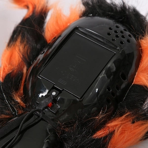 Detail of Halloween spider battery compartment with speaker and orange black fur