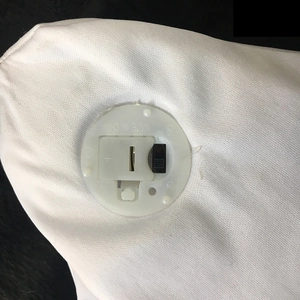 Detail of the white fabric ghost with a circular plastic battery box and power switch