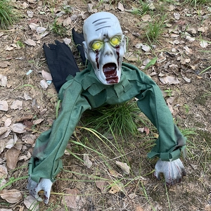 Creepy crawling zombie with blood tears and green cloth on autumn leaves for Halloween