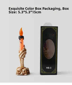 Close-up of Halloween skeleton hand candle lamp with skull base and spiderweb gift box