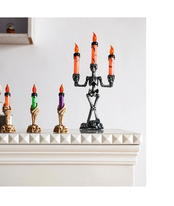 Detail view of Halloween LED skeletal candle holders with glowing orange faux flames
