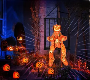 Glow-in-the-dark Halloween cage ghost decoration with orange pumpkin face in night garden