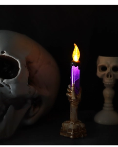 Detailed view of Halloween purple LED candle light with skull hand base and glitter effect