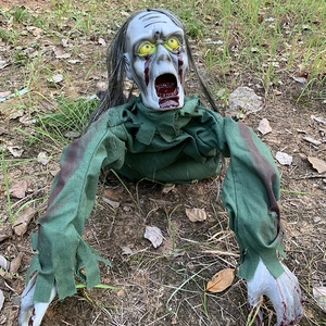 Animated crawling zombie prop with grey hair and blood stains for Halloween yard decor