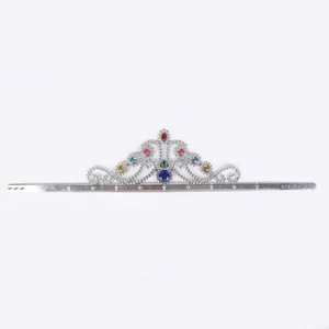 Close-up of silver king crown with colorful rhinestones and intricate scroll patterns
