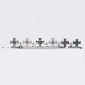 Detail view of silver plastic crown headband with colorful gems and adjustable buckle