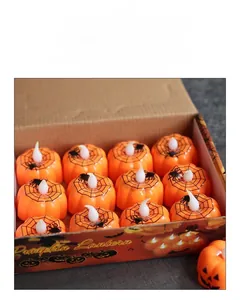 Macro view of 12-piece Halloween LED pumpkin lights with black spider web patterns