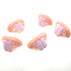 Detailed view of 5 funny tongue and teeth shoe charms for clogs decoration