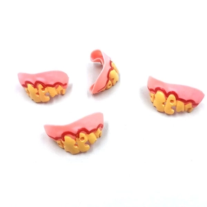 Macro detail of monster zombie false teeth set with realistic yellowed enamel and gums