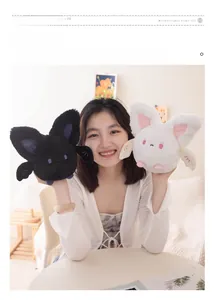 Asian model holding cute plush bats in black and white colors with soft fur texture