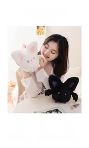 Close-up of soft black and white plush bat toys featuring cute wings and embroidery