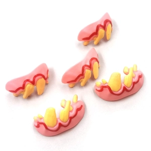 Macro detail of funny dog dentures showing realistic yellow teeth and pink gums accessory