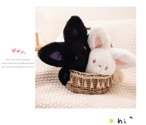 Detail of cute black and white round bat plush toys in a woven basket for Halloween gift