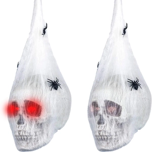 Hanging Halloween skull wrapped in spider webs with glowing red eyes and black spiders