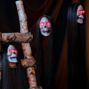 Three-piece glowing skull set with long black hair and red LED eyes for Halloween decor
