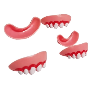 Detailed view of Halloween vampire fangs and funny dog teeth dentures for cosplay props