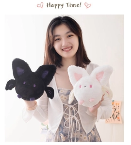 Detailed view of hand-held soft plush bat toys in black and white styles