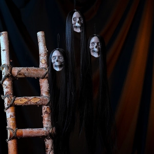 Macro detail of three spooky skulls with long black hair for Halloween scene props