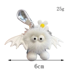 Detail showing a white plush bat keychain with dimensions 6cm and 25g weight