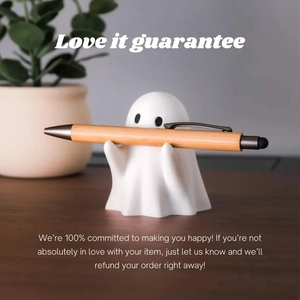 Ghost pen holder desktop ornament holding a ballpoint pen in a cozy office setting
