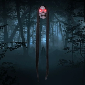 Hanging Halloween skull with long black hair and glowing red LED eyes for haunted house decor