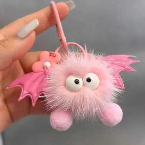 Cute pink plush monster bat keychain with fluffy faux fur and large round eyes
