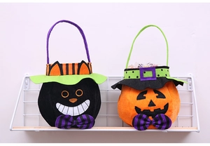 Close-up of Halloween treat bags featuring a black cat and a classic orange pumpkin design