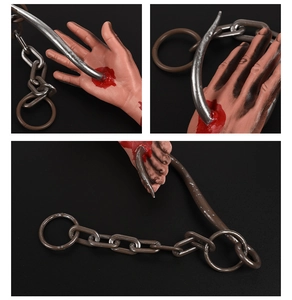 Detailed close-up of bloody prosthetic hand and foot with metal hooks for Halloween decor