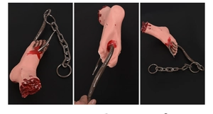 Realistic Halloween prop featuring a bloody severed foot with large metal hook and chain