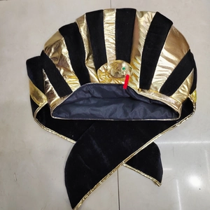 Detail of Egyptian pharaoh hat featuring gold snake ornament and black velvet stripes