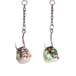 Halloween zombie head props with blood splatters on metal hooks and plastic chains