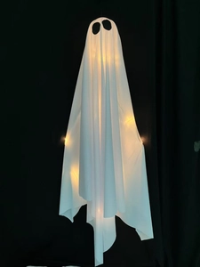 Close-up of a glowing white ghost hanging ornament with warm LED lights for Halloween