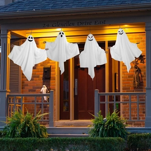 Four white hanging ghosts with diverse expressions on a porch for Halloween outdoor decor