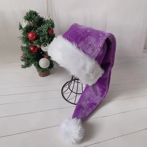 Extra long 75cm purple plush Christmas hat with white faux fur trim on wood floor
