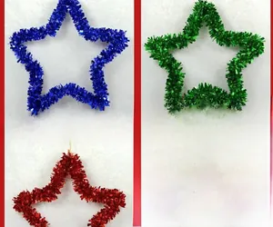 Close-up of sparkling blue, green, and red star-shaped tinsel garlands for Christmas decor