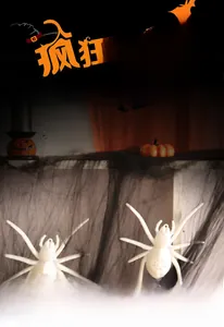 Detail of white Halloween LED spiders with web patterns hanging on black mesh