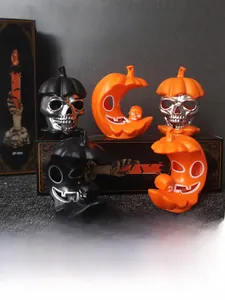 Detail of Halloween LED pumpkin and skull lanterns with metallic silver and orange finish