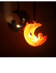 Detail of moon-shaped Halloween LED light with skull decor and hanging rope