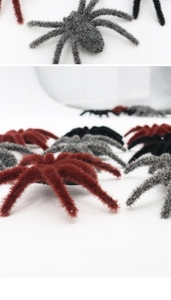 Close-up of realistic flocked Halloween spiders in red, gray and black with fur texture