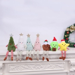 Detailed view of plush Christmas dolls with striped legs on a white fireplace