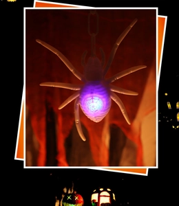 Detail of LED glowing spider pendant with blue light effect for Halloween party decor