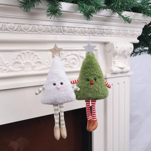 Close-up of white and green Christmas plush dolls with long legs hanging on a fireplace