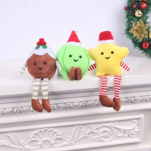 Detailed view of Christmas plush ornaments featuring pudding, sprout and star on a white mantel