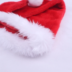 Close-up detail of high-quality long plush white trim and red fabric on the Christmas hat