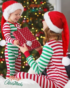 Detail of red and green striped family Christmas pajamas with soft velvet holiday hats