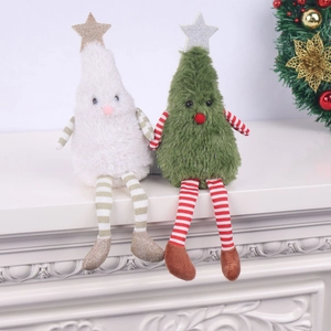 Close-up of cute white and green plush Christmas tree dolls with long striped legs