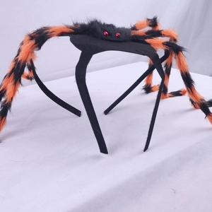 Detail view of Halloween pet spider headband with fuzzy black and orange legs and red eyes