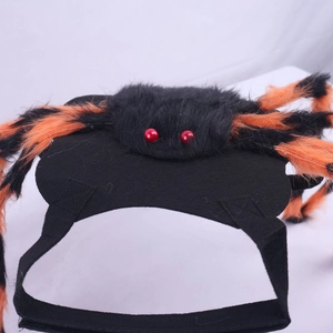 Detail of spider costume for dogs featuring fuzzy orange and black legs and red eyes