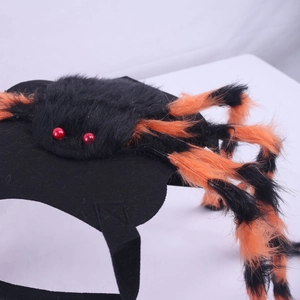 Close-up of Halloween pet spider costume with orange plush legs and red bead eyes